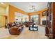 Spacious living room with a fireplace, ceiling fan, and views into a modern kitchen at 7371 Vanguard Ct, Stanley, NC 28164