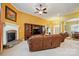 Cozy living room with a fireplace, built-in shelving, and comfortable leather furniture at 7371 Vanguard Ct, Stanley, NC 28164