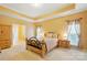 Inviting main bedroom with neutral tones, tray ceiling, and comfortable bed and furniture at 7371 Vanguard Ct, Stanley, NC 28164