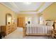 Spacious main bedroom with tray ceiling, soft carpet, and coordinated furniture set at 7371 Vanguard Ct, Stanley, NC 28164