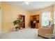 Cozy office area with a custom desk, ample shelving, and natural light from a large window at 7371 Vanguard Ct, Stanley, NC 28164