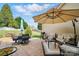 Spacious patio with outdoor seating, an umbrella, and a grill, perfect for entertaining at 7371 Vanguard Ct, Stanley, NC 28164