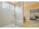 Bright bathroom with a frameless glass shower featuring a built-in bench and elegant tile work at 7371 Vanguard Ct, Stanley, NC 28164