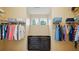 Organized walk-in closet with custom shelving, drawers, and natural light from a large window at 7371 Vanguard Ct, Stanley, NC 28164