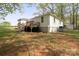 Wide shot of the home's backyard featuring a deck, grassy area, and surrounding trees at 751 & 767 Pettit Rd, Catawba, SC 29704