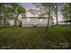 Side view of the home with a small deck and a glimpse of the carport at sunset at 751 & 767 Pettit Rd, Catawba, SC 29704