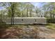 Exterior front view of manufactured home surrounded by trees at 751 & 767 Pettit Rd, Catawba, SC 29704