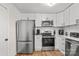 Modern kitchen with stainless steel appliances and white cabinets at 751 & 767 Pettit Rd, Catawba, SC 29704