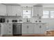 Bright and clean kitchen featuring stainless steel dishwasher and white cabinets at 751 & 767 Pettit Rd, Catawba, SC 29704