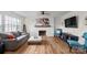 Bright and airy living room showcasing hardwood floors, a gray sofa, and a modern fireplace at 751 & 767 Pettit Rd, Catawba, SC 29704