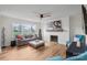 Bright living room featuring hardwood floors, brick fireplace, and large windows at 751 & 767 Pettit Rd, Catawba, SC 29704