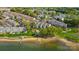 Scenic aerial view of lakeside condos featuring lush landscaping and private beach access for residents to enjoy at 7836 Village Harbor Dr, Cornelius, NC 28031
