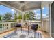 Balcony with lake views features two chairs, a small table, a ceiling fan and scenic outdoor landscape at 7836 Village Harbor Dr, Cornelius, NC 28031