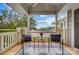 Balcony with lake views features two chairs, a small table, scenic views, and a ceiling fan at 7836 Village Harbor Dr, Cornelius, NC 28031