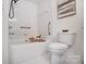 Bright bathroom featuring an all-white tile scheme and a shower and tub combination at 7836 Village Harbor Dr, Cornelius, NC 28031