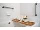 The bathtub features a bamboo tray, perfect for relaxing at 7836 Village Harbor Dr, Cornelius, NC 28031