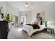Bright bedroom with white walls, ceiling fan, balcony access and a decorative accent wall painting at 7836 Village Harbor Dr, Cornelius, NC 28031
