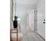 Bright entryway with tiled floors, a decorative mirror, and a view into the carpeted hallway at 7836 Village Harbor Dr, Cornelius, NC 28031
