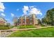Beautiful condo complex with brick facade, manicured lawn, and lush landscaping at 7836 Village Harbor Dr, Cornelius, NC 28031