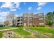 Beautiful condo complex with brick facade, manicured lawn, and lush landscaping at 7836 Village Harbor Dr, Cornelius, NC 28031
