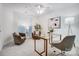 Bright home office featuring a glass desk, comfortable seating, and ample natural light at 7836 Village Harbor Dr, Cornelius, NC 28031