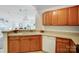 The bright kitchen features wood cabinetry, stone countertops, and views to the dining room at 7836 Village Harbor Dr, Cornelius, NC 28031