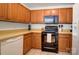The kitchen features ample wood cabinetry, stone countertops, and modern appliances at 7836 Village Harbor Dr, Cornelius, NC 28031