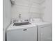 Functional laundry room featuring a Maytag washing machine and a dryer, with overhead shelving at 7836 Village Harbor Dr, Cornelius, NC 28031