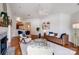 Open-concept living room with wood floors, fireplace, and dining area at 7836 Village Harbor Dr, Cornelius, NC 28031