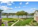 Beautiful waterfront property with lush green lawn, mature trees, and a scenic view of the lake and marina at 7836 Village Harbor Dr, Cornelius, NC 28031