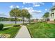 Scenic view of the lakefront property featuring a wooden walkway, green lawn, and a view of the marina at 7836 Village Harbor Dr, Cornelius, NC 28031