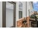 Private balcony featuring a dark-bricked wall, window and a chair with plants on the side at 791 Seigle Point Dr, Charlotte, NC 28204