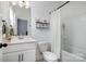 Cozy bathroom features a vanity sink, a standard toilet, and a shower-tub combination with a white curtain at 791 Seigle Point Dr, Charlotte, NC 28204
