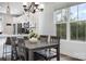 Cozy dining area features a dark wood table and modern chandelier lighting, next to the open kitchen area at 791 Seigle Point Dr, Charlotte, NC 28204