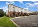 Row of townhomes with two-car garages, balconies and well-maintained landscaping on a sunny day at 791 Seigle Point Dr, Charlotte, NC 28204