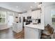 Well-lit kitchen includes stainless appliances, white cabinetry, island and barstool seating at 791 Seigle Point Dr, Charlotte, NC 28204