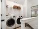 Bright laundry room with front-loading LG washer and dryer, storage shelf, and neat linen arrangement at 791 Seigle Point Dr, Charlotte, NC 28204