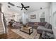 Spacious living room with modern ceiling fan, plush gray sofas, and a decorative area rug at 791 Seigle Point Dr, Charlotte, NC 28204