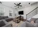 Bright living room with a ceiling fan, comfortable sofas, decorative rug, and staircase at 791 Seigle Point Dr, Charlotte, NC 28204
