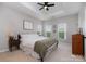 Bright main bedroom featuring a comfortable king bed, tray ceiling, and multiple windows at 791 Seigle Point Dr, Charlotte, NC 28204