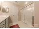 Bathroom featuring a glass enclosed shower and a vanity with cabinets at 8603 Bookwalter Ct, Charlotte, NC 28277