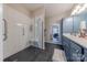 Bathroom featuring walk-in shower with bench, grab bars, a double vanity, and blue cabinets at 8603 Bookwalter Ct, Charlotte, NC 28277