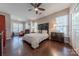 Light filled bedroom with wood floors, ceiling fan, two windows and vintage furnishings at 8603 Bookwalter Ct, Charlotte, NC 28277