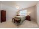 Bedroom featuring natural light from a window, neutral carpeting, and ample space at 8603 Bookwalter Ct, Charlotte, NC 28277