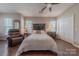 Comfortable bedroom with ceiling fan, closet, and vintage furnishings at 8603 Bookwalter Ct, Charlotte, NC 28277