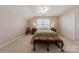 Bright bedroom with neutral walls, a cozy bed, and a window for natural light at 8603 Bookwalter Ct, Charlotte, NC 28277