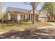 Well-maintained home with tidy landscaping, a manicured lawn, and a brick and white exterior at 8603 Bookwalter Ct, Charlotte, NC 28277