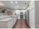 Bright eat-in kitchen featuring granite countertops, stainless steel appliances, and wood floors at 8603 Bookwalter Ct, Charlotte, NC 28277