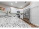 Bright kitchen featuring stainless appliances, granite countertops and sleek white cabinetry at 8603 Bookwalter Ct, Charlotte, NC 28277