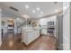 Open kitchen with stainless steel appliances, granite counters, view of staircase and adjacent living area at 8603 Bookwalter Ct, Charlotte, NC 28277